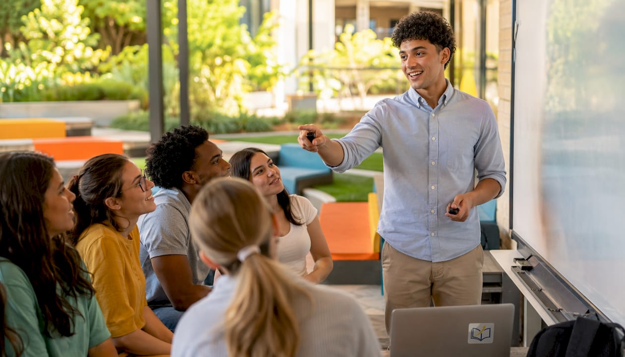 Teacher presenting AI use to students in bright school library